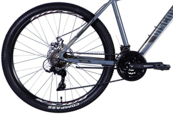 Close-up of a mountain bike's rear wheel and gears.