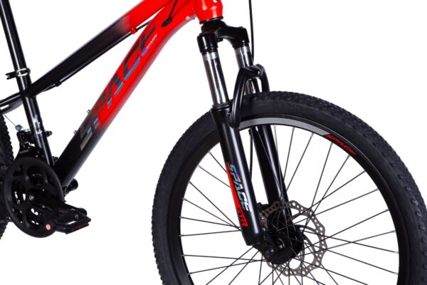 Close-up of a red mountain bike's front fork