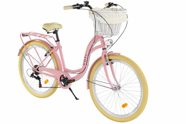Rosa cykel med korg fram och beige däck.