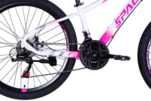 Close-up of a pink and white bicycle drivetrain.